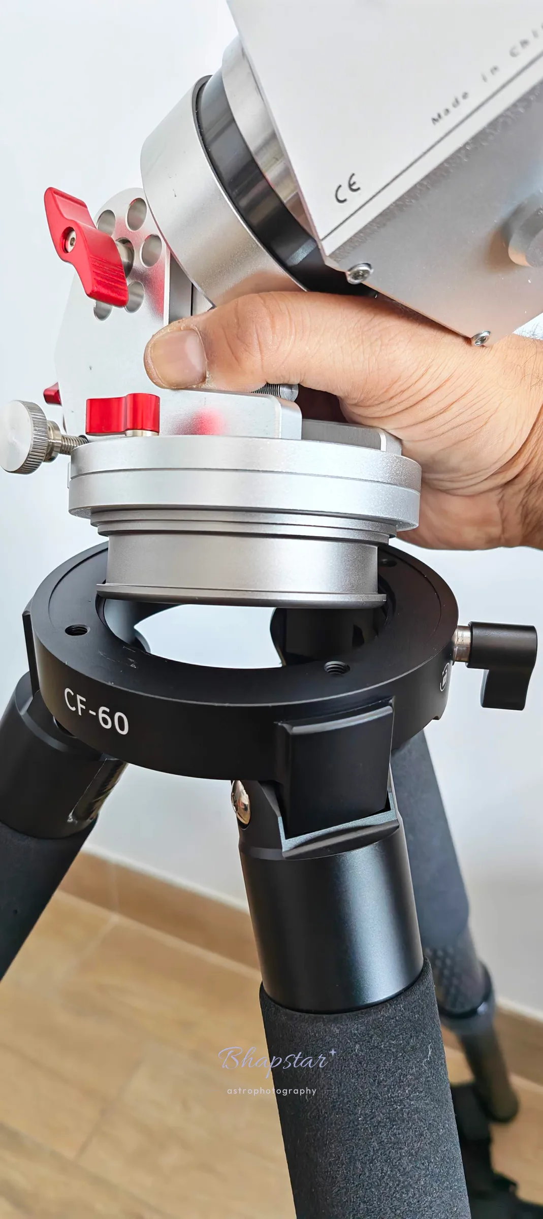 An equatorial mount being lowered onto the CF-60 top plate