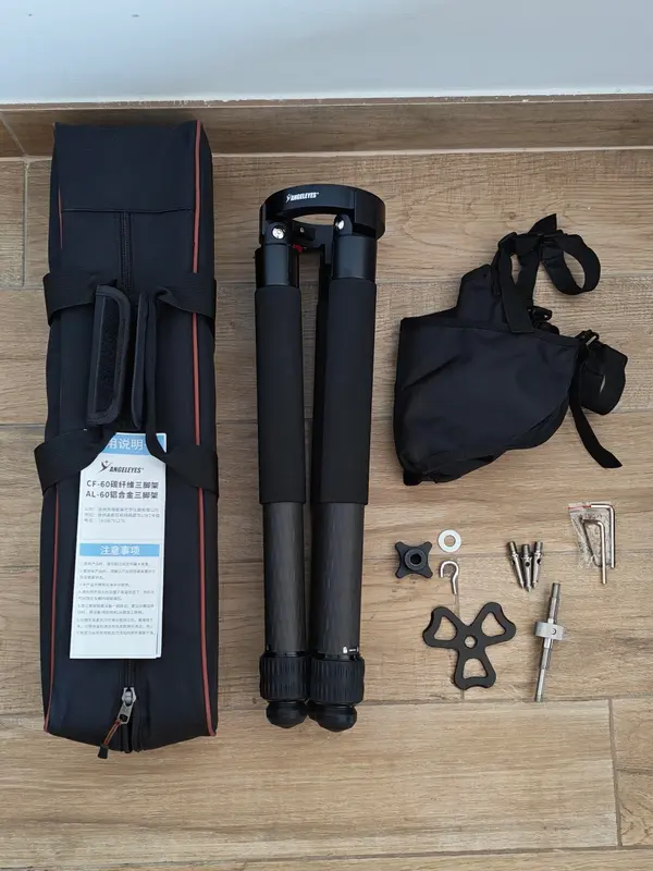 Angeleyes CF-60 unboxed, with the folded tripod, storage bag, sandbag, grass spikes, centre rod, triangular brace and tools laid out on the floor
