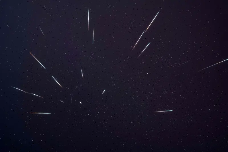 Dozens of Geminid meteor trails recorded across a starfield over one night and combined into a single frame