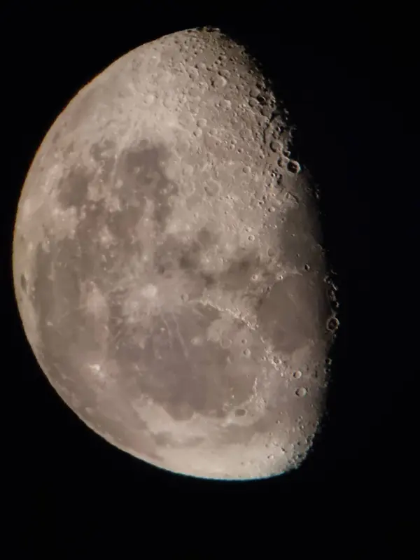 The Moon photographed close up, with craters and dark lava plains clearly visible across the face